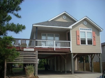Front of the house. Sitting on the Adirondack chairs is great.