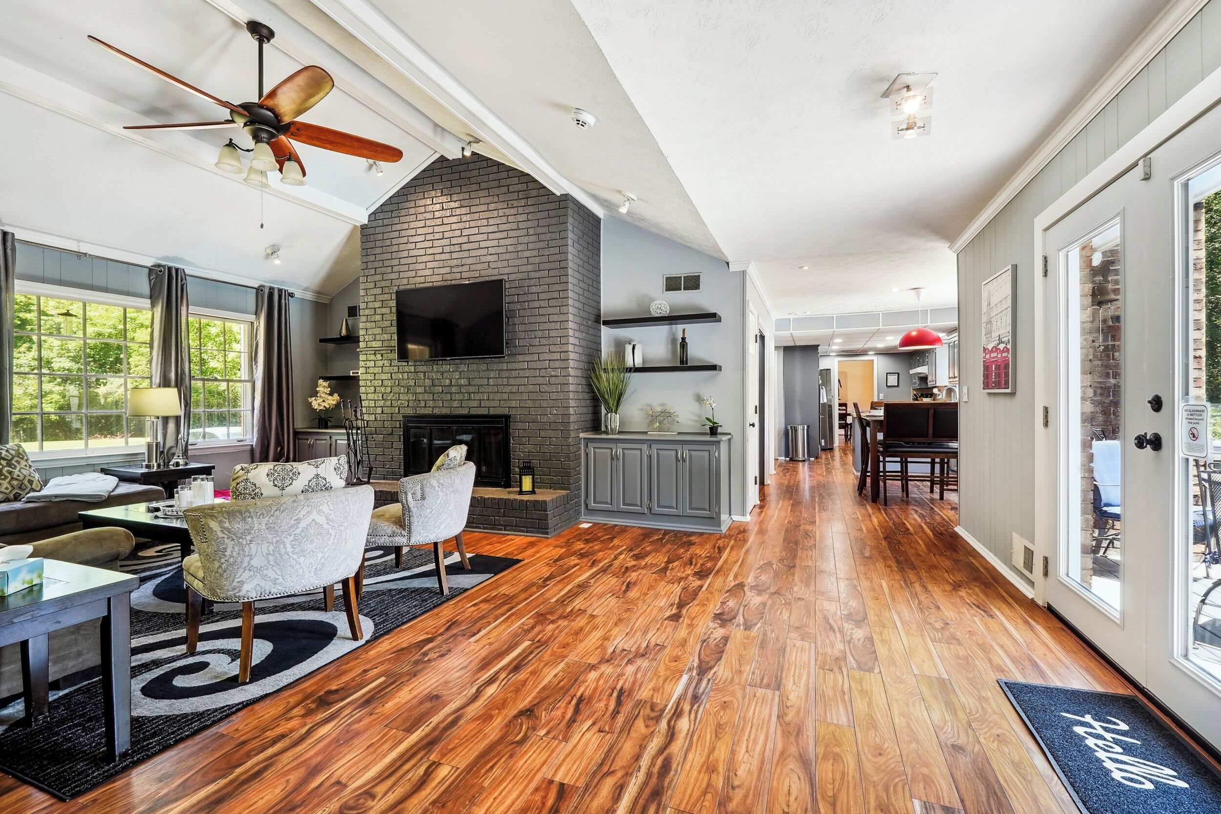 Living Room with TV & access to Garage & Upper Back Patio -Main Level 