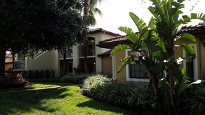 A residential building with a garden, a large tree, and a well-maintained lawn. - Ultimate Orlando Adventure: Orange Lake Resort - Disney, Universal, Sea World! (Kissimmee)