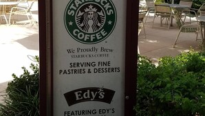 A sign for a Starbucks coffee shop at a resort, featuring a menu of pastries, desserts, and ice cream. - Ultimate Orlando Adventure: Orange Lake Resort - Disney, Universal, Sea World! (Kissimmee)