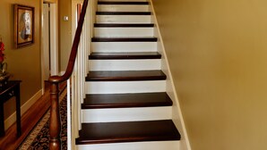 A staircase with dark wooden steps and white risers, leading to a door at the top. - Destination, Overlooking Cooperstown, Large Grounds, 6.2 miles from Dreams Park. (COOPERSTOWN)