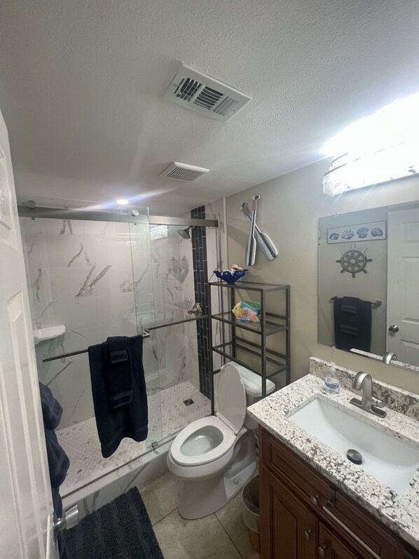 A bathroom with a toilet, shower, and sink. - Beachfront, Heart Of Destin Fl (Destin)