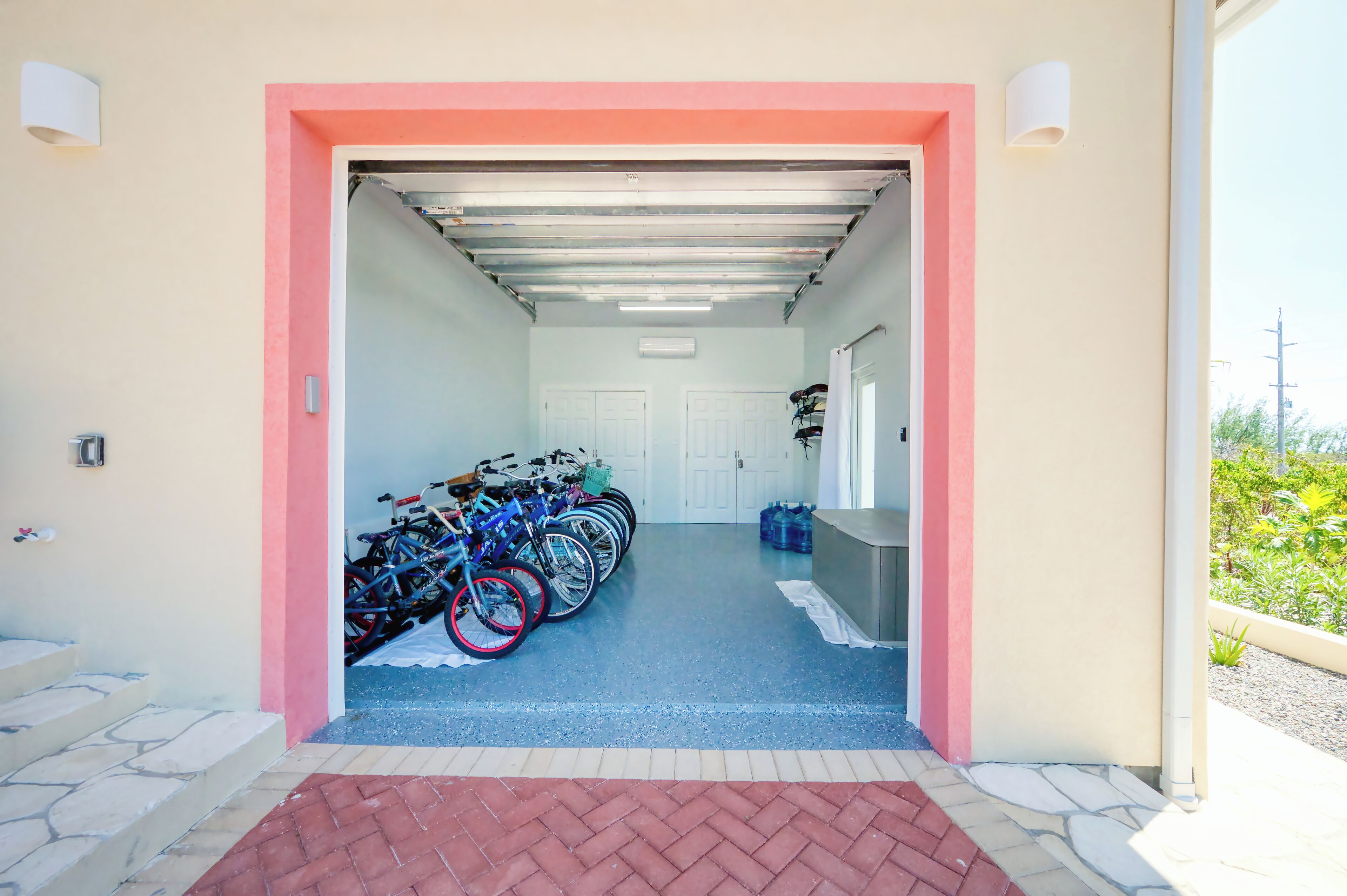 A covered bike parking area with multiple bicycles and a water dispenser.