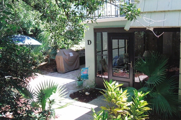 Condo entrance surrounded by lush vegetation adding to privacy