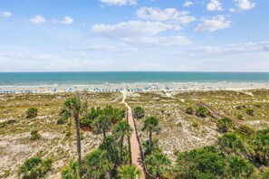Relax on the beach with lounge chairs and umbrellas, and stroll along the boardwalk through the dunes and palm trees.