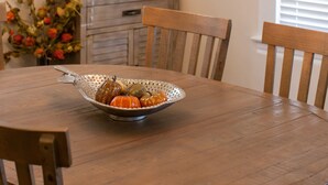 A dining table with a decorative bowl and a chandelier. - Two Master-King Suites+! (Sonoma)