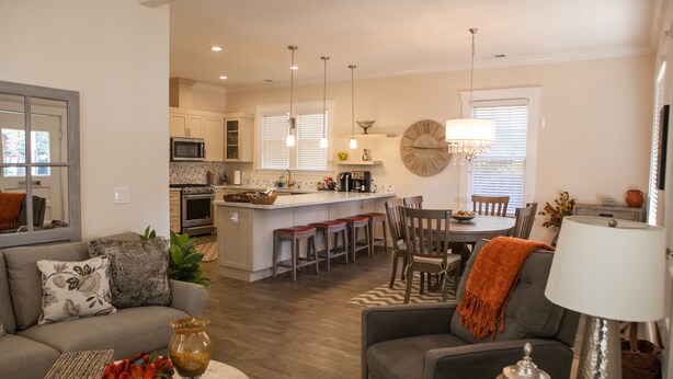 A modern kitchen with a central island, bar stools, and pendant lighting. - Two Master-King Suites+! (Sonoma)