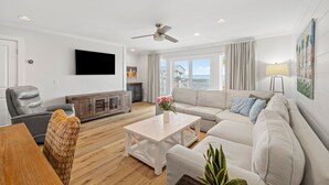 A modern living room with a sofa, armchairs, a coffee table, and a television. - Gulf-front 30A Townhome -  Steps to the Beach.
FALL IS RIGHT AROUND THE CORNER.. (Seagrove Beach)