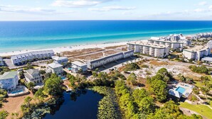 A coastal hotel with multiple buildings, a beach, and a small lake surrounded by greenery. - Gulf-front 30A Townhome -  Steps to the Beach.
FALL IS RIGHT AROUND THE CORNER.. (Seagrove Beach)