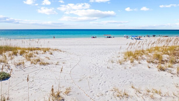 A beach with white sand, sparse grass, and a clear blue sky. - Gulf-front 30A Townhome -  Steps to the Beach.
FALL IS RIGHT AROUND THE CORNER.. (Seagrove Beach)