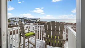 A balcony with two Adirondack chairs, a view of the beach, and a row of houses in the background. - Gulf-front 30A Townhome -  Steps to the Beach.
FALL IS RIGHT AROUND THE CORNER.. (Seagrove Beach)