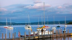 A marina with several sailboats docked at wooden piers.