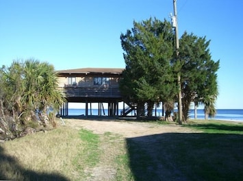 View of the cottage from the West - Decks and porch face east and south
