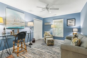 Relax in this stylish living room with a sofa, armchairs, and a small table.