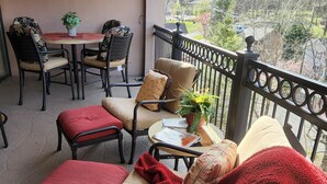 A balcony with a sofa, chairs, a small table, and a potted plant. - LABOR DAY WKEND $175/NGHT SPECIAL! 
A CANCELLATION =GREAT HOLIDAY OPP 4 U!





 (Gatlinburg)