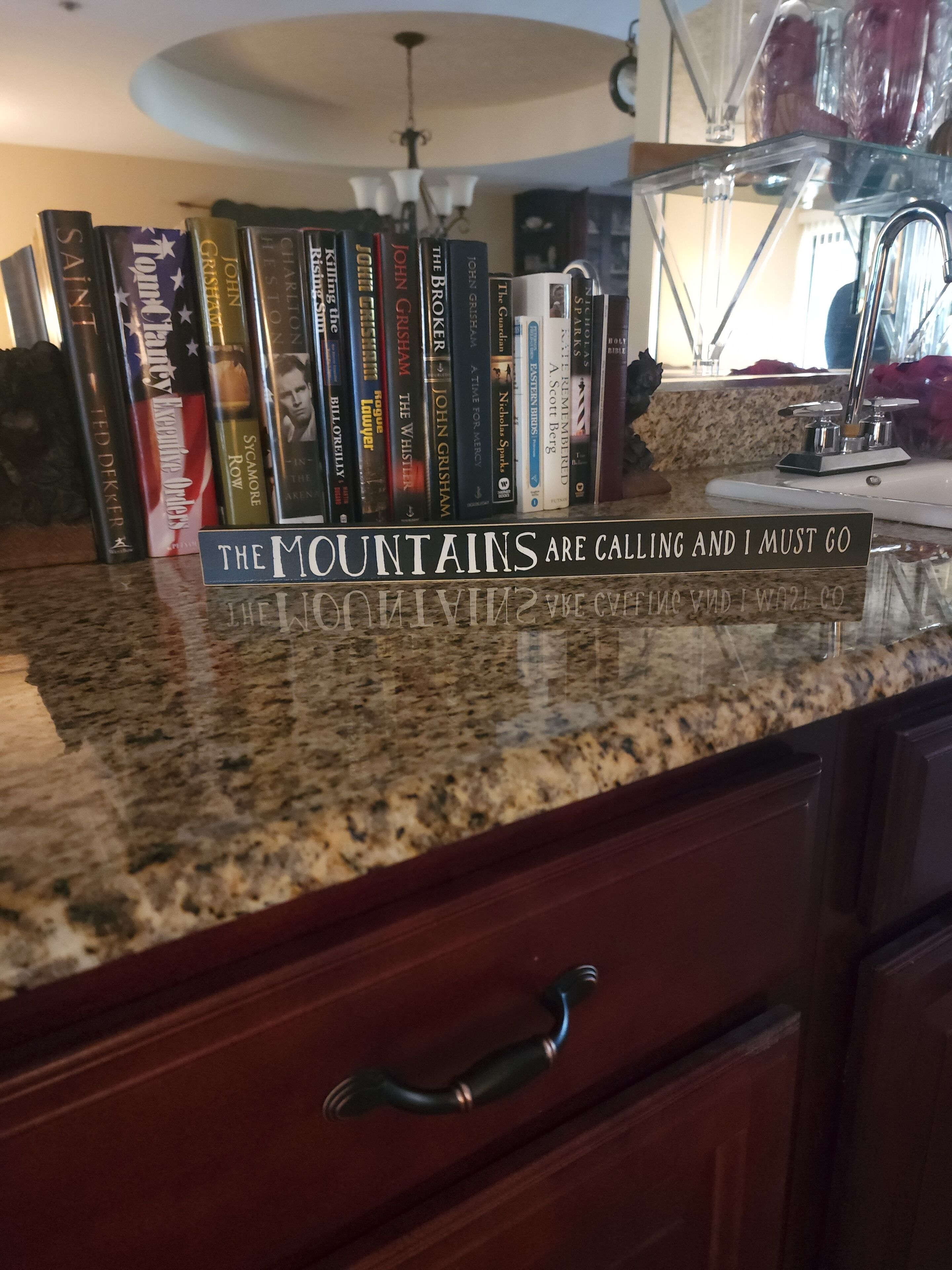 A kitchen counter with a granite top and a drawer with a black handle.