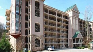 A multi-story hotel with a central courtyard, featuring a mix of stone and brick facades, and a distinctive corner tower. - LABOR DAY WKEND $175/NGHT SPECIAL! 
A CANCELLATION =GREAT HOLIDAY OPP 4 U!





 (Gatlinburg)