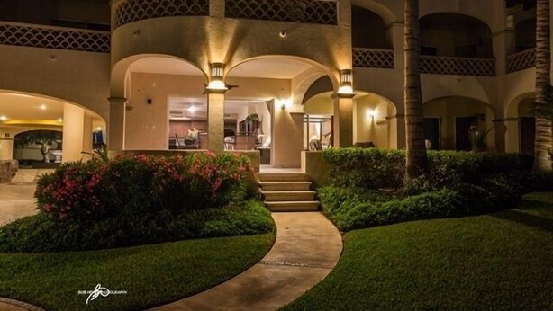 A multi-level building with arched walkways and outdoor seating areas. - Las Mananitas-Awesome Luxury Beachside Condo in Cabo! (san jose del cabo)