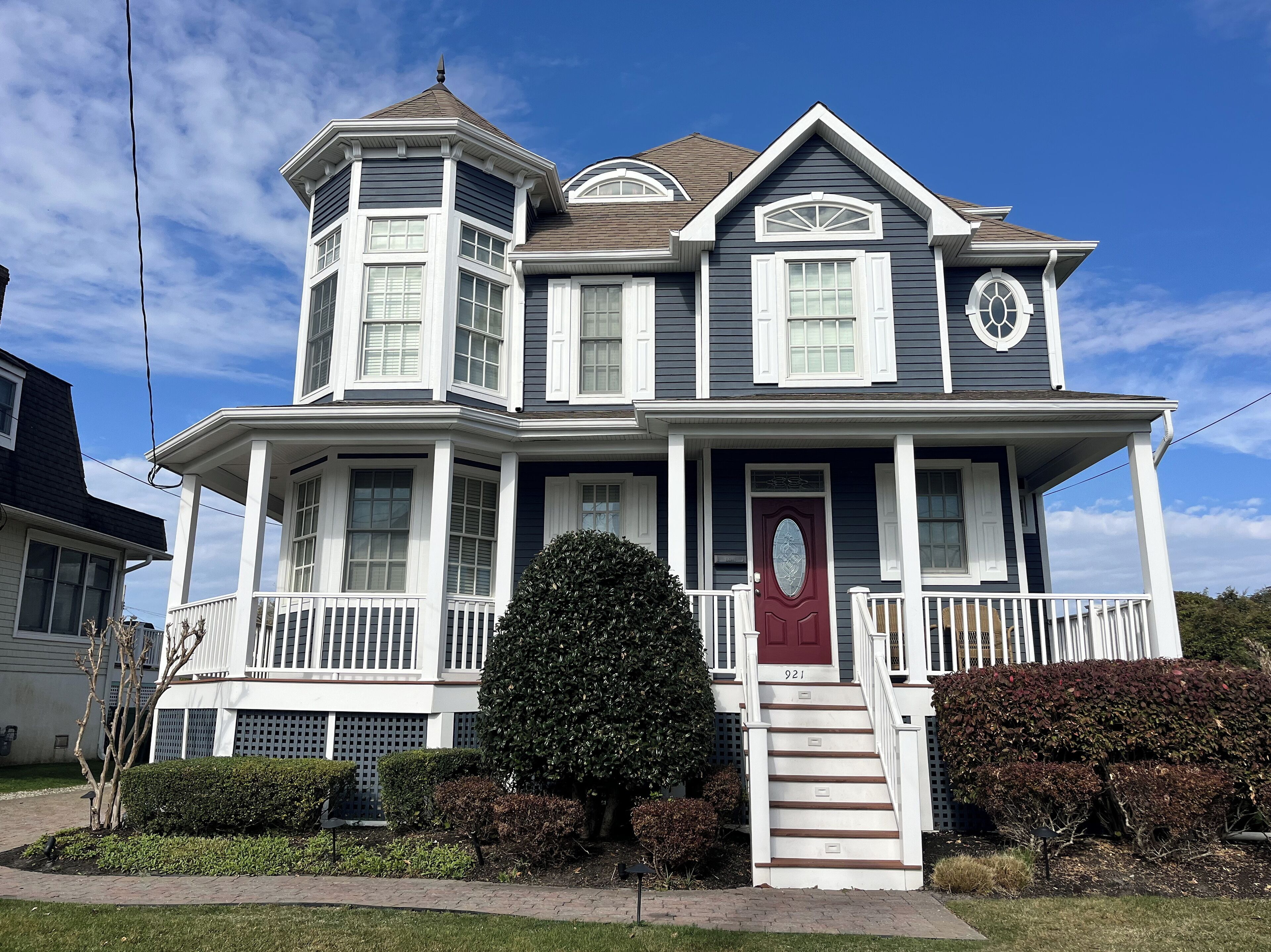 Modern Victorian home is spacious & meticulous! Front porch with rocking chairs.