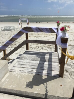 Stroll along the beach walkway to a picturesque archway, surrounded by a serene ocean view.