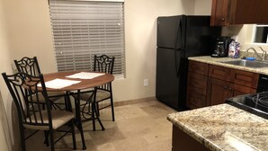 A kitchen with a dining table, chairs, a refrigerator, a sink, and a stove. - Clean, renovated 1 Bedroom with everything you need. Granite, Travertine! (Tucson)