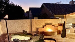 A backyard with a swimming pool, a fire pit, and a grill area. - Old Town Scottsdale oasis with resort style back yard!!! (Scottsdale)