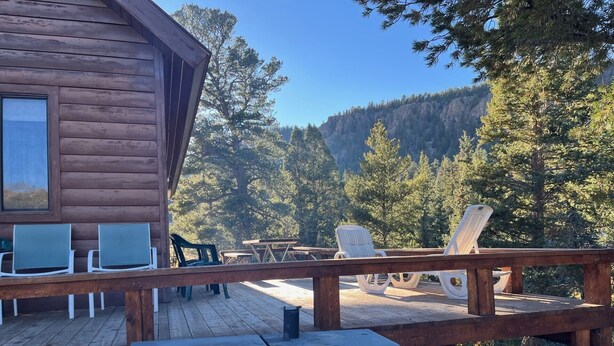 A wooden deck with outdoor seating and a barbecue grill. - Riverfront Paradise - Minutes from Wolf Creek Ski Area (South Fork)