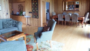 A cozy wooden interior with a living room, dining area, and kitchen. - Beautiful Oceanfront Home, Gorgeous Views, Deck and Patio! Best Value! (Encinitas)