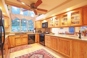 Enjoy cooking in this well-equipped kitchen with a large island, stove, and dishwasher.