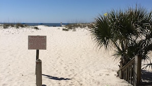 A sandy beach with a sign indicating it is a private beach with specific rules. - SEPTEMBER BEACH TIME... NO CROWDS..LOW PRICES! (Gulf Shores)