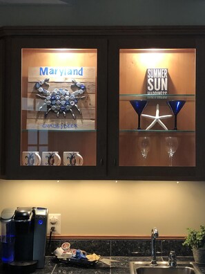 Experience the local charm with a display case featuring a Maryland beer cap collection and seasonal sign.