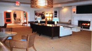 A spacious living room with a fireplace, a pool table, and a comfortable seating area. - Four Season Aviara                            (Carlsbad)