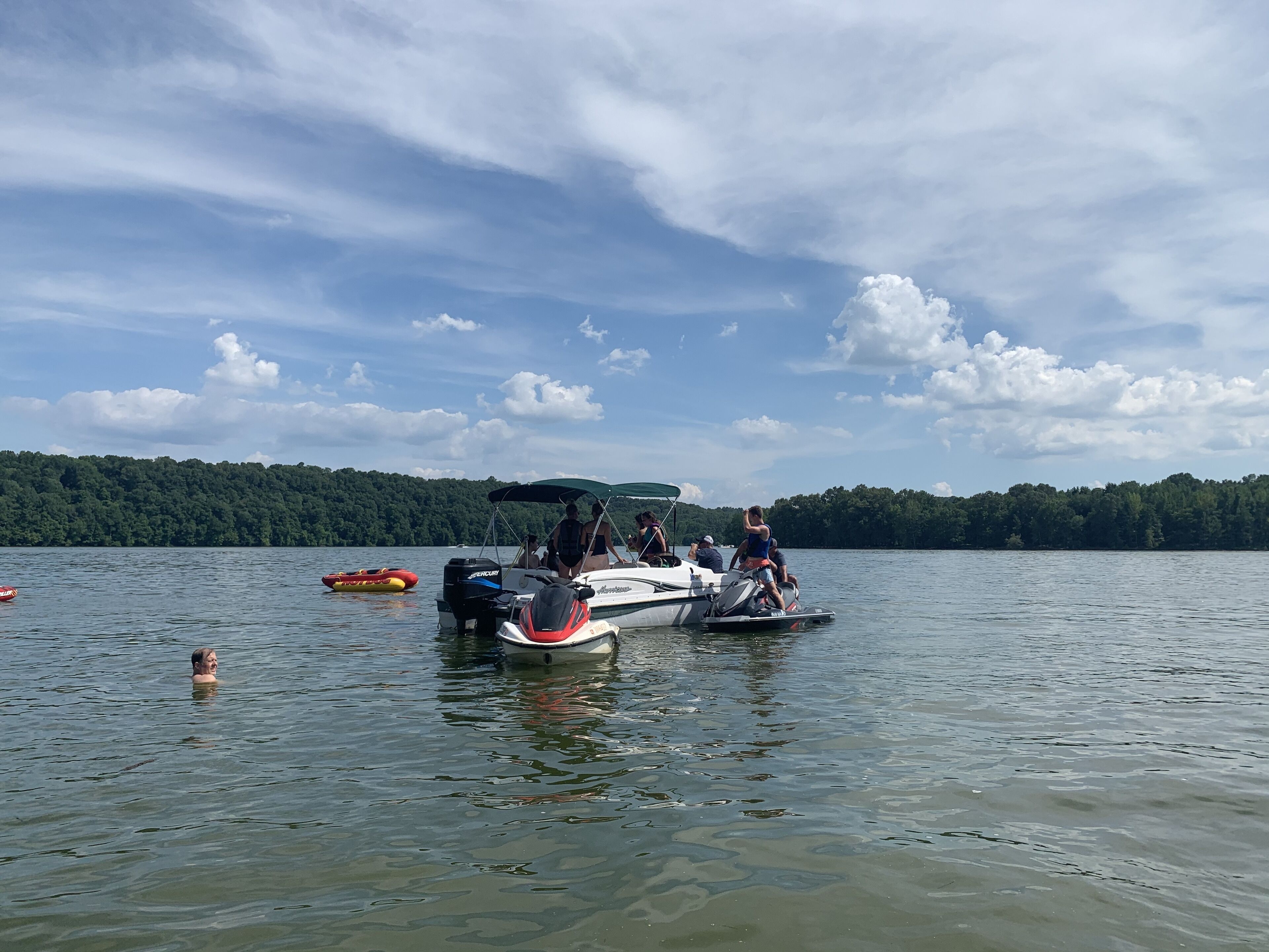 A lake with boats and people on the water.
