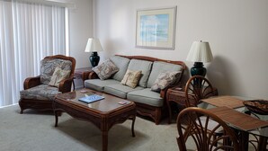 A living room with a sofa, armchairs, a coffee table, and a dining table. - Beautiful 2 Bedroom, 2 Bath Ocean View Condo in Surfside Beach (Surfside Beach)