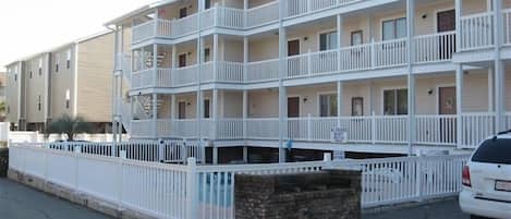 A multi-story motel with white railings and balconies.