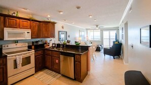 Una cocina amplia con armarios de madera, lavavajillas de acero inoxidable y una isla grande.
