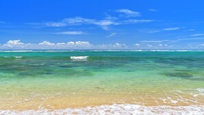 A beach with clear turquoise water and a sandy shore. - Waipouli Beach Resort - Ground Floor #E103,  2 King Masters Suites (Kapaa)