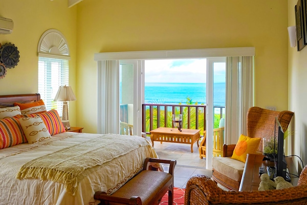 The main bedroom has a king-size bed and great views of Shoal Bay.