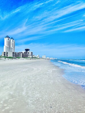 A beach with buildings in the background.