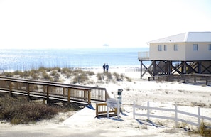 A beach house with a wooden deck and a sign indicating beach access. - Best First Tier House - Located in beautiful Morgantown (Gulf Shores)