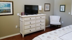 A bedroom with a bed, a dresser, a television, and framed artwork on the walls. - SAWGRASS PONTE VEDRA BEACH (Ponte Vedra Beach)