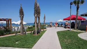 A pathway lined with palm trees and a beach view. - SAWGRASS PONTE VEDRA BEACH (Ponte Vedra Beach)