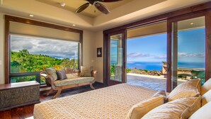 A bedroom with a large bed, a chaise lounge, and a view of the ocean. - Kula Luxury Retreat With Stunning Ocean & Mountain Views! (Kula)