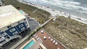 A beachfront hotel with a swimming pool, beach access, and ocean views.