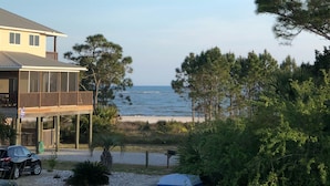 A coastal property with a house overlooking the beach, a covered outdoor area, and a parking area with a car. - Southern Tide in Indian Pass 😊 (Indian Pass)