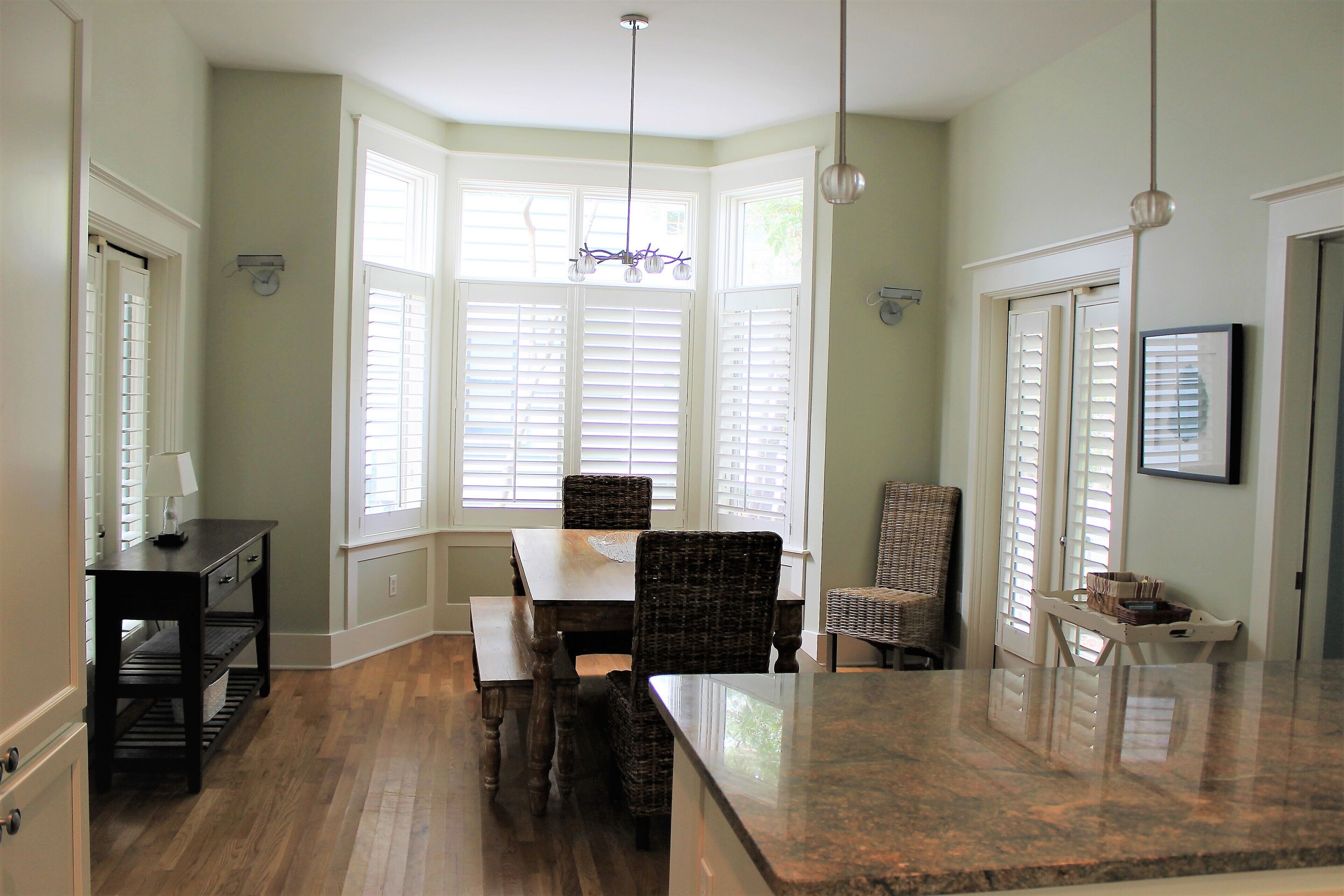 A dining area with a table, chairs, and a bench.