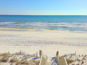 A beach with a wooden fence and a clear view of the ocean. - 5 BR, 5 BA in Seaside, quick walk to the private beach access or main pool  (Santa Rosa Beach)