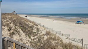 A beach with a wooden fence, a gazebo, and a clear sky. - BLUE HAVEN-COROLLA-OBX (Corolla)