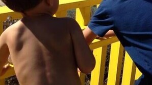 Two children looking out at the ocean from a yellow railing. - Walk everywhere; Beach 300 steps (Laguna Beach)