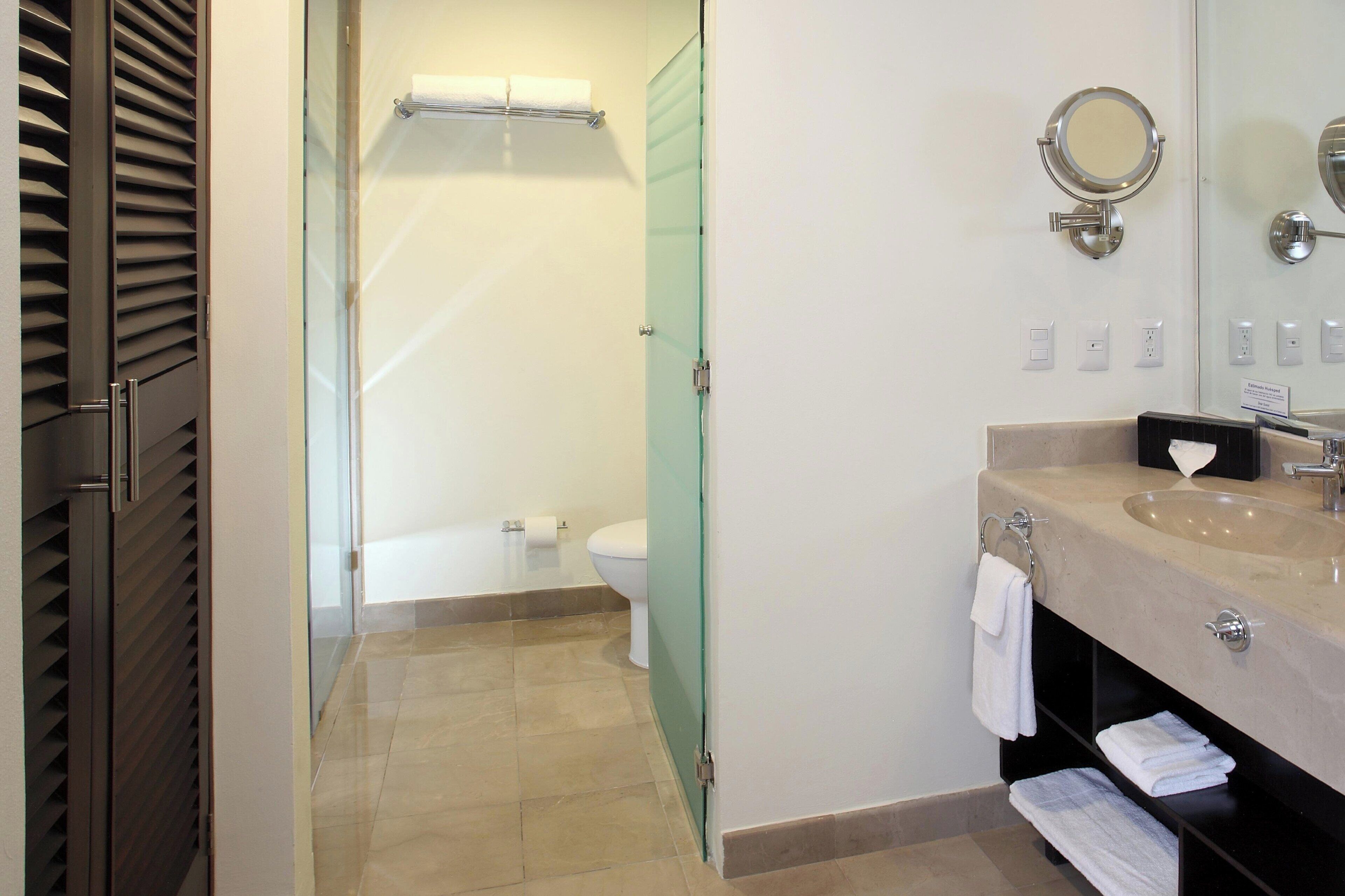 room, 1 king bed, balcony, partial ocean view | bathroom | shower, free toiletries, hair dryer, towels